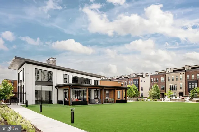 a front view of residential houses with yard and green space