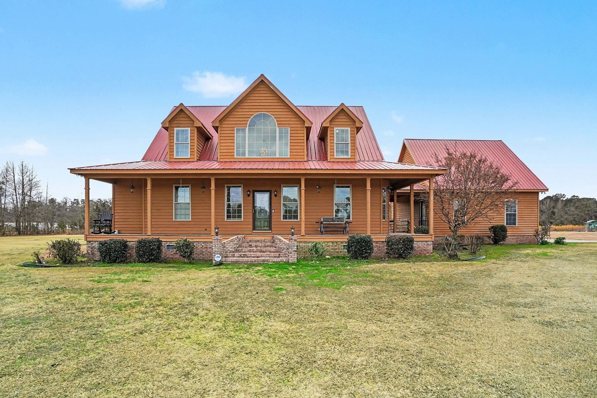 202 Highway 747 Loris Sc 29569 Loris, SC 29569 - Photo 2 of 34 View of front of house with a porch, a front yard, a metal roof, and crawl space