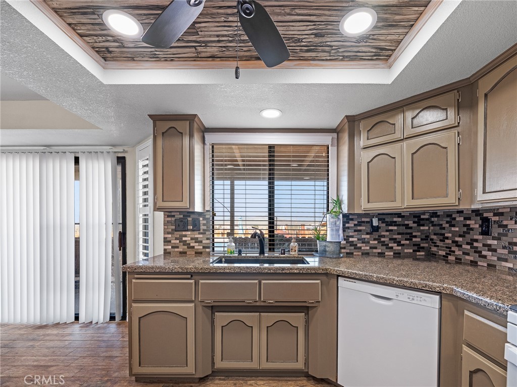 16986 Ocotilla Road Apple Valley, CA 92307 - Photo 12 of 39 a bathroom with a granite countertop sink and a window