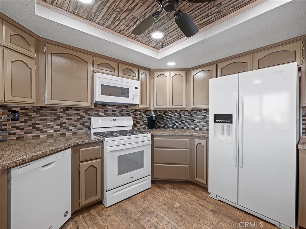 16986 Ocotilla Road Apple Valley, CA 92307 - Photo 13 of 39 a kitchen with stainless steel appliances white cabinets and a refrigerator