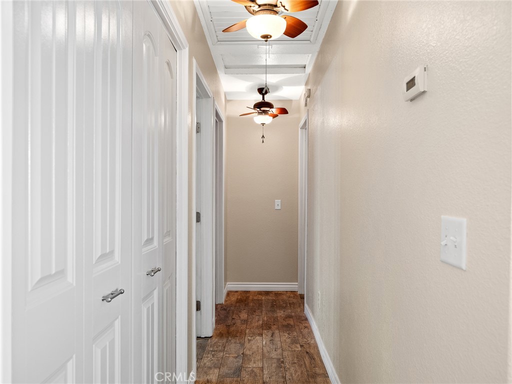 16986 Ocotilla Road Apple Valley, CA 92307 - Photo 17 of 39 a view of a hallway with wooden floor and closet