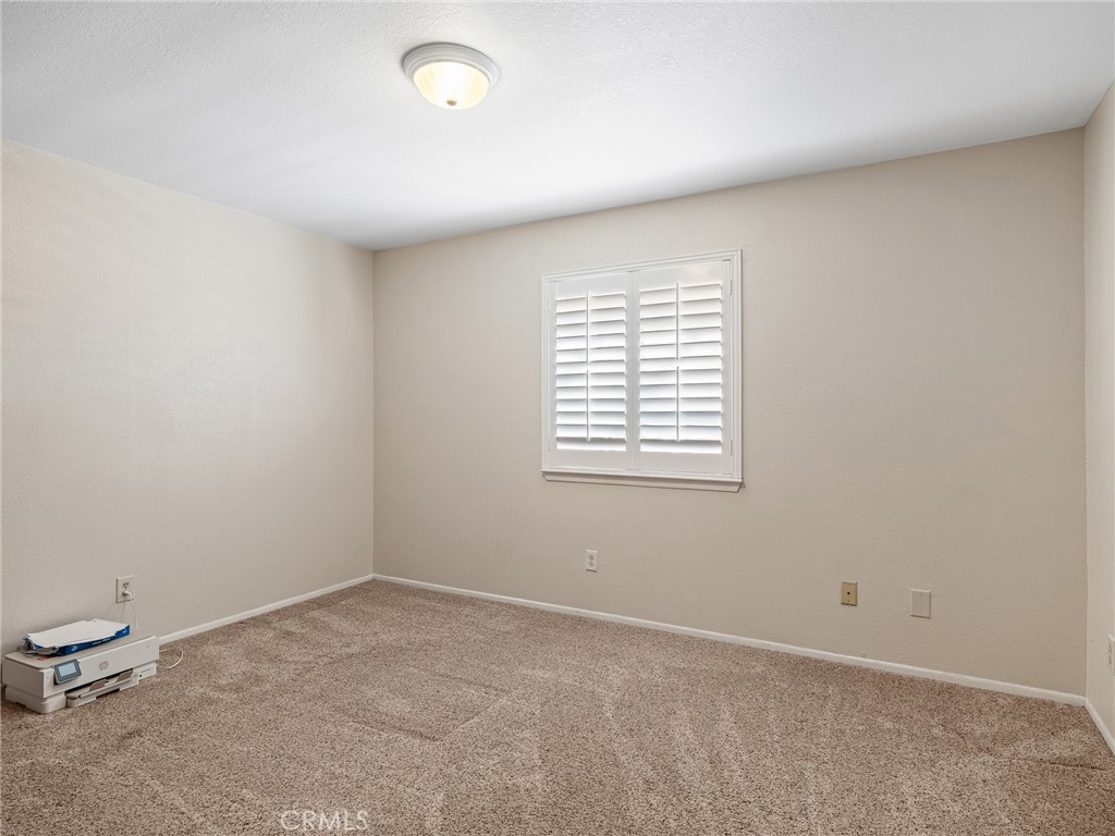 16986 Ocotilla Road Apple Valley, CA 92307 - Photo 22 of 39 an empty room with a window