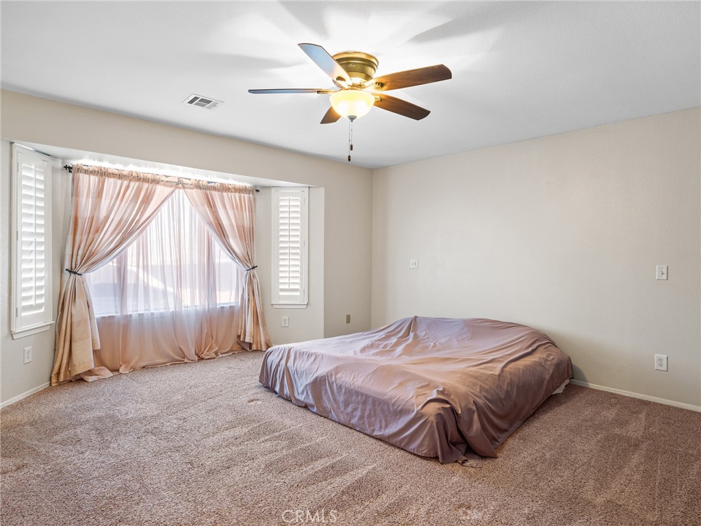 16986 Ocotilla Road Apple Valley, CA 92307 - Photo 23 of 39 a bedroom with a bed and window