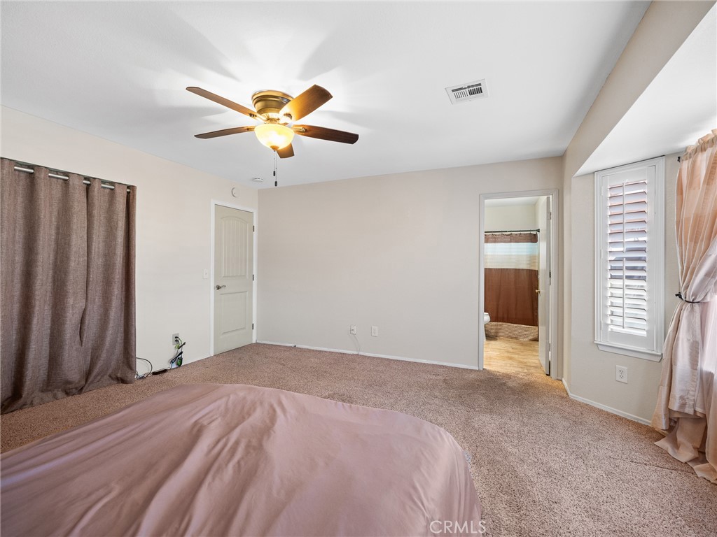 16986 Ocotilla Road Apple Valley, CA 92307 - Photo 24 of 39 a bedroom with a bed and a window