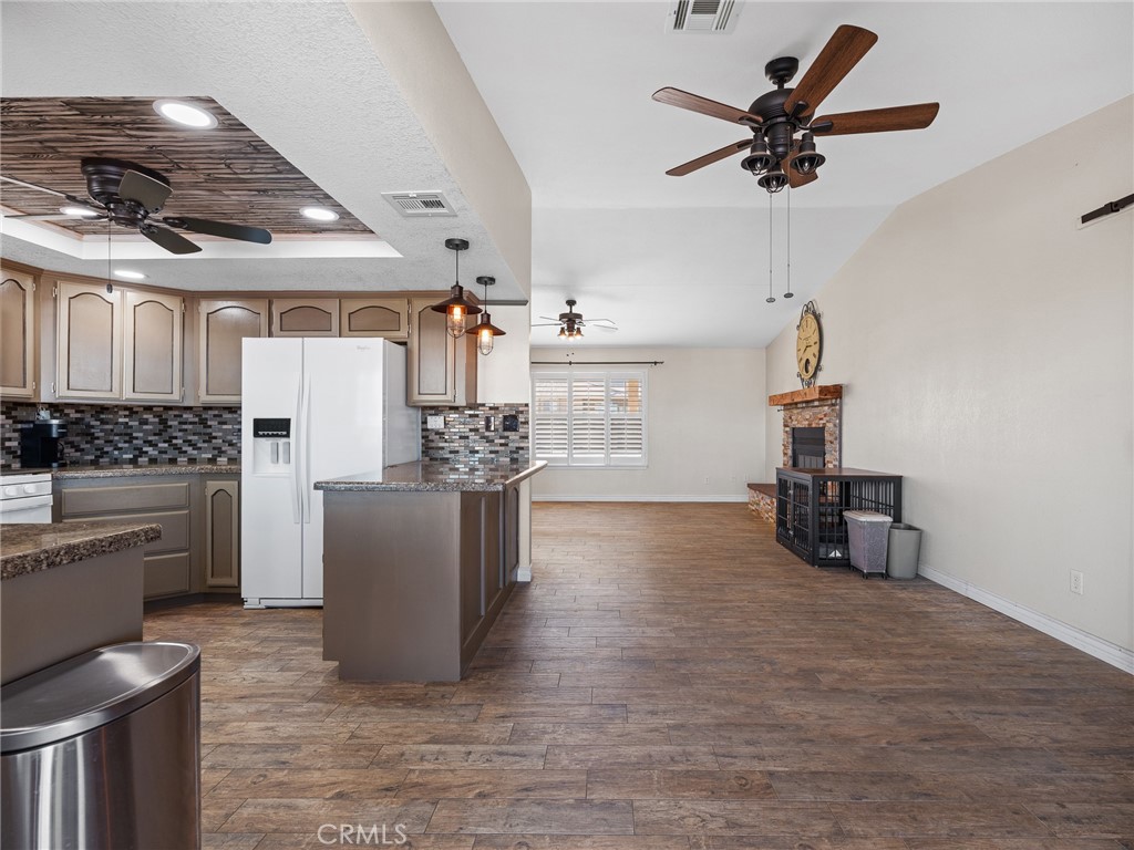 16986 Ocotilla Road Apple Valley, CA 92307 - Photo 28 of 39 a kitchen with a refrigerator and white cabinets