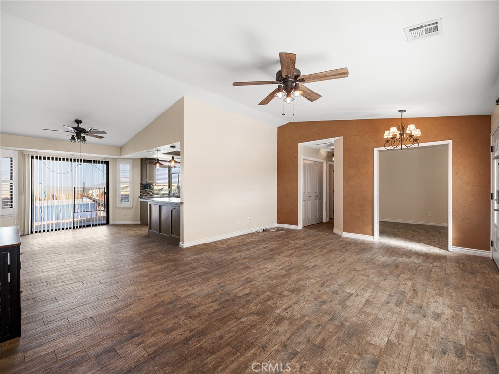 16986 Ocotilla Road Apple Valley, CA 92307 - Photo 5 of 39 a view of empty room with wooden floor and windows