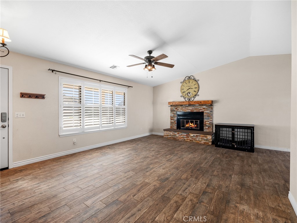 16986 Ocotilla Road Apple Valley, CA 92307 - Photo 6 of 39 a view of an empty room with a fireplace and a window