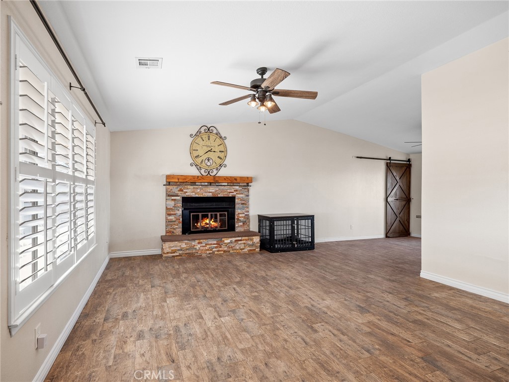 16986 Ocotilla Road Apple Valley, CA 92307 - Photo 7 of 39 a view of an empty room with a fireplace and a window