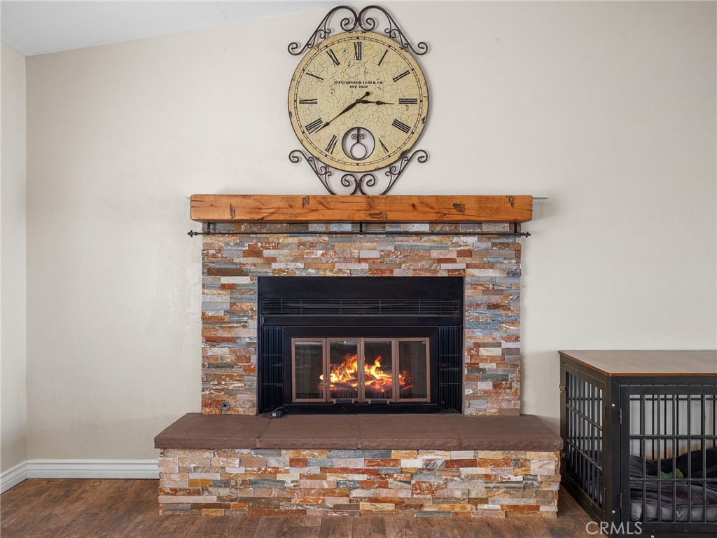 16986 Ocotilla Road Apple Valley, CA 92307 - Photo 8 of 39 a fireplace with a clock on top of it
