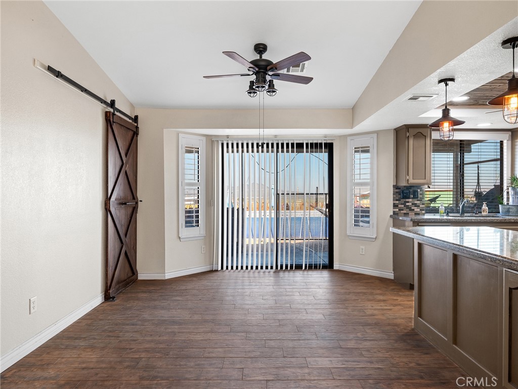 16986 Ocotilla Road Apple Valley, CA 92307 - Photo 9 of 39 a view of a livingroom with a ceiling fan and hardwood floor