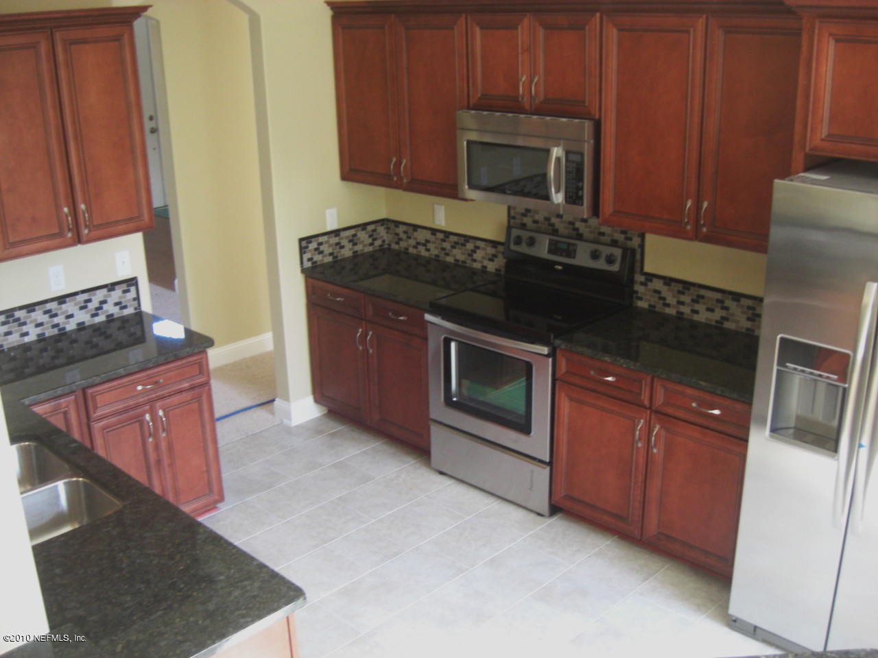 1934 Derringer Road Jacksonville, FL 32225 - Photo 8 of 15 a kitchen with granite countertop stainless steel appliances a stove a microwave a sink and cabinets