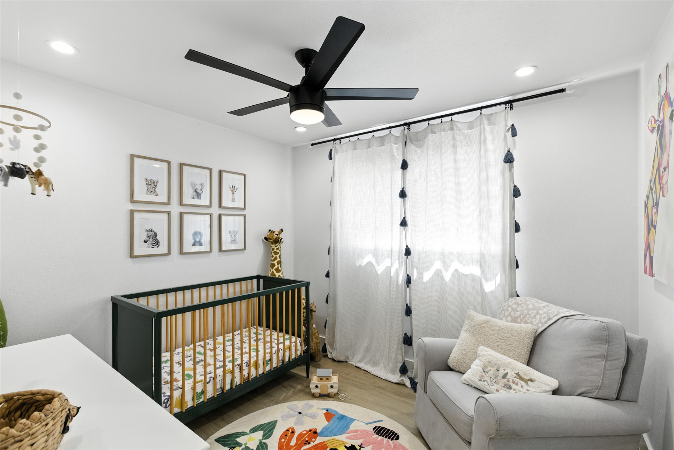 2403 Gateshead Circle Austin, TX 78745 - Photo 18 of 22 Recessed lighting and a ceiling fan illuminate this calm, inviting room, creating a serene space.
