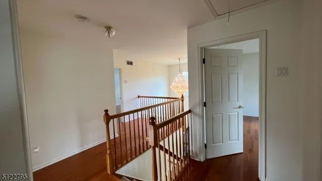 a view of a hallway with a door and stairs