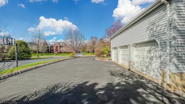 a view of a house with a yard and pathway