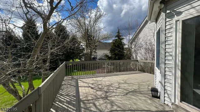 a view of balcony with wooden floor and fence