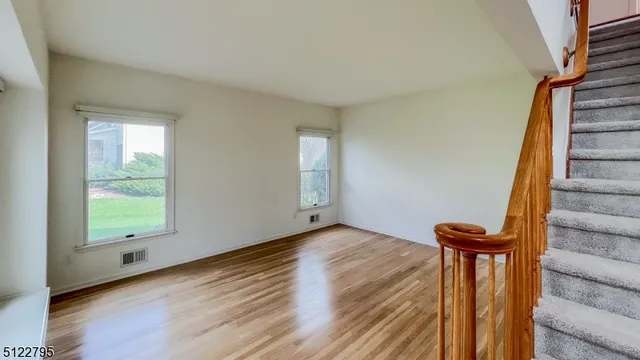 a view of a room with wooden floor and stairs