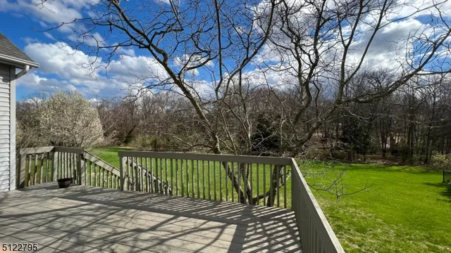 a view of a wooden deck with a backyard