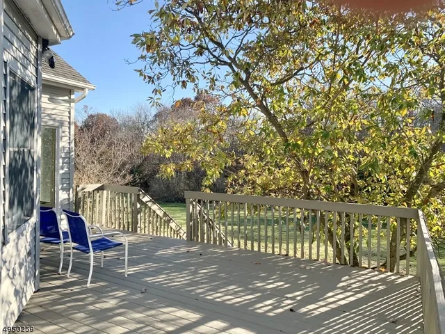 a view of a patio with table and chairs and floor to ceiling window