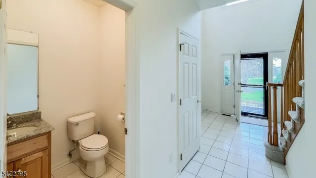 a bathroom with a granite countertop toilet and a shower