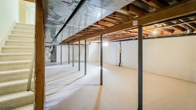a view of a hallway with wooden floor and an entryway