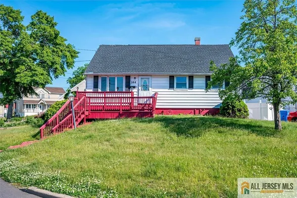 a view of a house with a backyard and a small yard