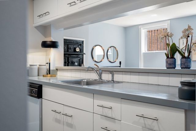 a kitchen with a sink and a refrigerator