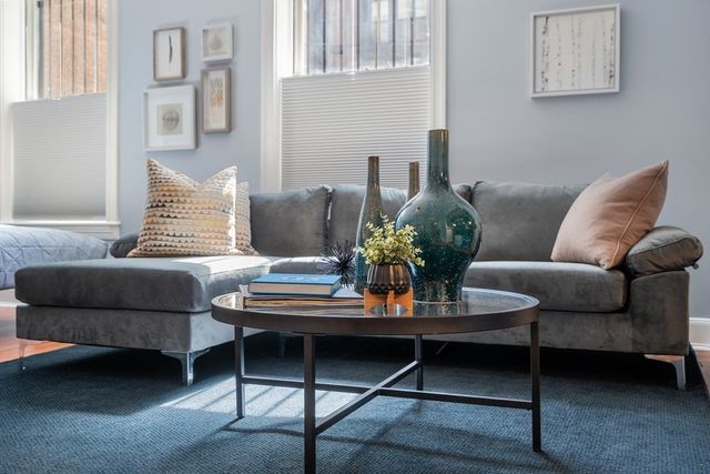 a living room with furniture and a potted plant