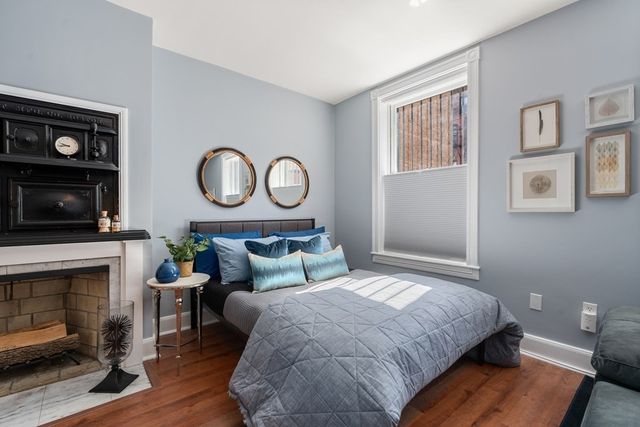 a bedroom with a bed and a fireplace