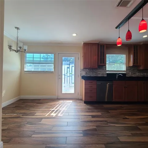 a kitchen with granite countertop wooden cabinets and window