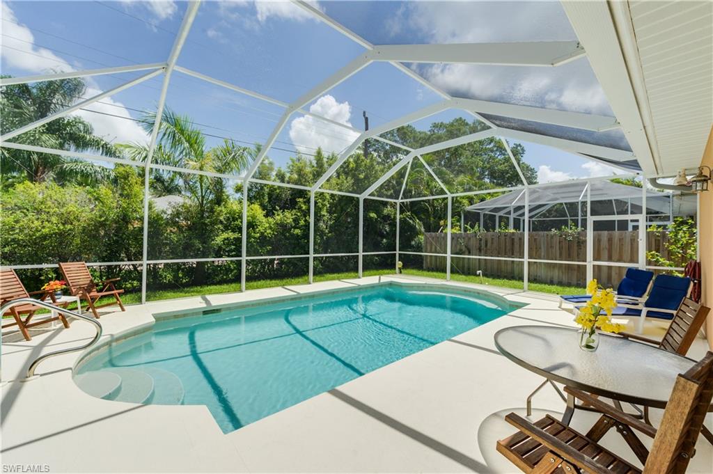 a view of a backyard with swimming pool