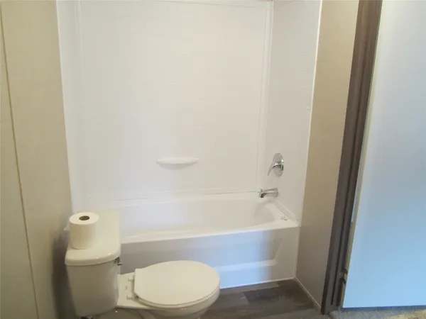 a bathroom with a toilet and a bathtub
