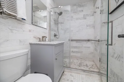a bathroom with a sink toilet and shower