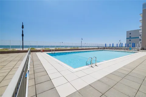 a view of swimming pool with outdoor seating