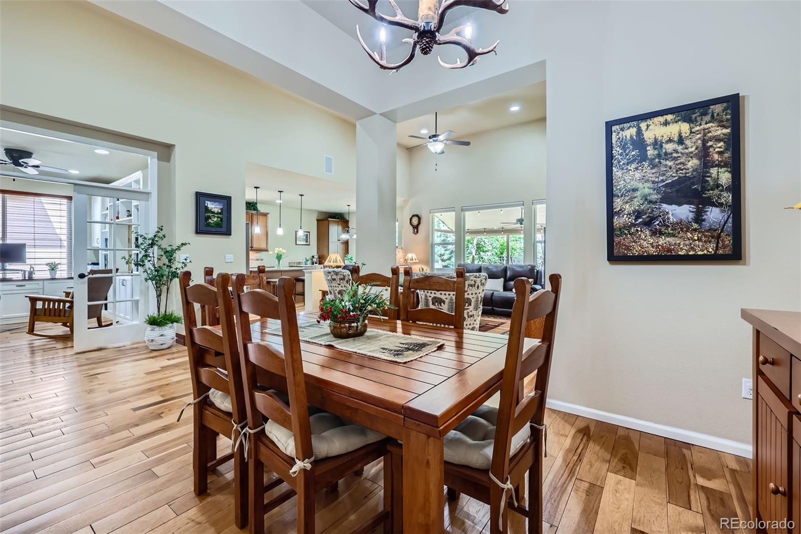 2872 Dreamcatcher Loop Castle Rock, CO 80109 - Photo 8 of 42 a view of a dining room with furniture and wooden floor