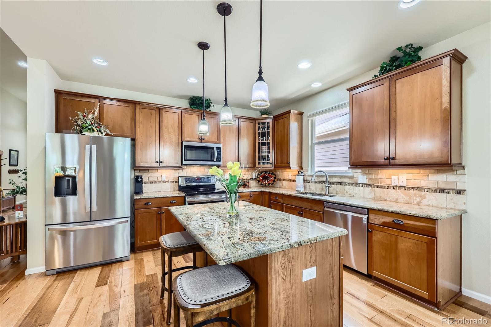 2872 Dreamcatcher Loop Castle Rock, CO 80109 - Photo 10 of 42 a kitchen with stainless steel appliances granite countertop a stove refrigerator and cabinets