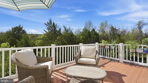 a view of a chair and table in the balcony