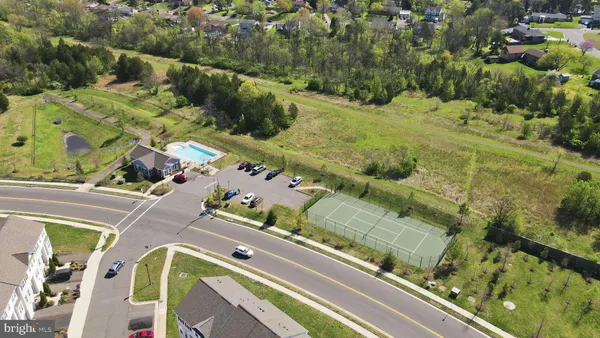 an aerial view of a residential houses with outdoor space