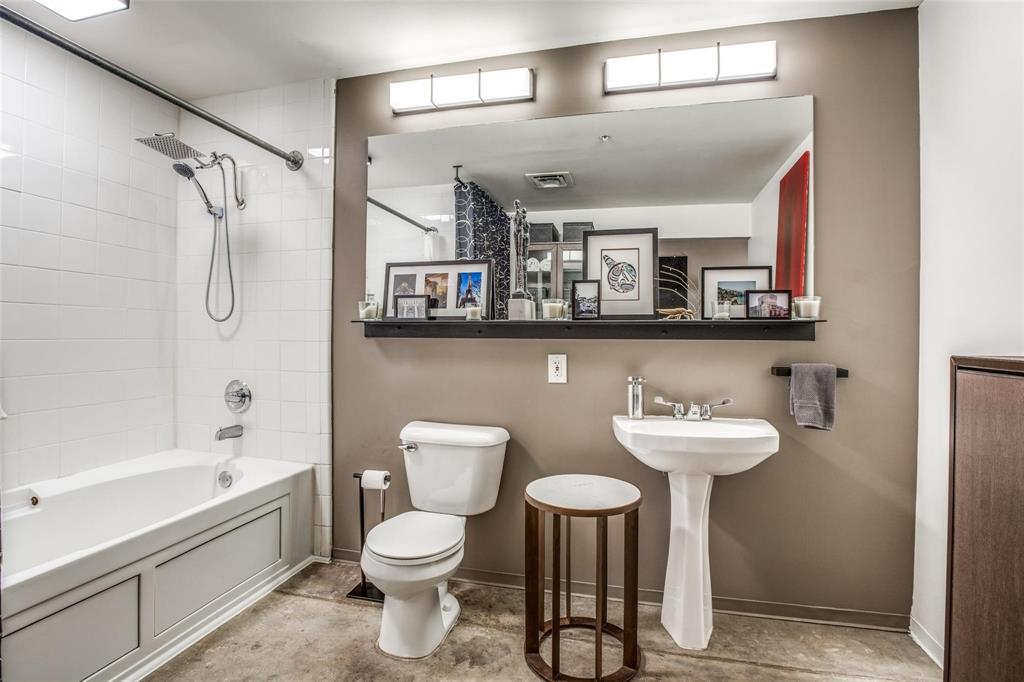 1122 Jackson Street, Unit 322 Dallas, TX 75202 - Photo 18 of 25 a bathroom with a toilet sink and mirror