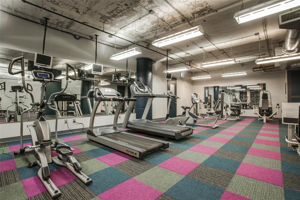 1122 Jackson Street, Unit 322 Dallas, TX 75202 - Photo 22 of 25 a room with gym equipment and mirrors