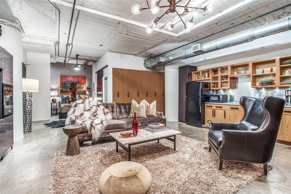 1122 Jackson Street, Unit 322 Dallas, TX 75202 - Photo 6 of 25 a living room with patio furniture and a chandelier