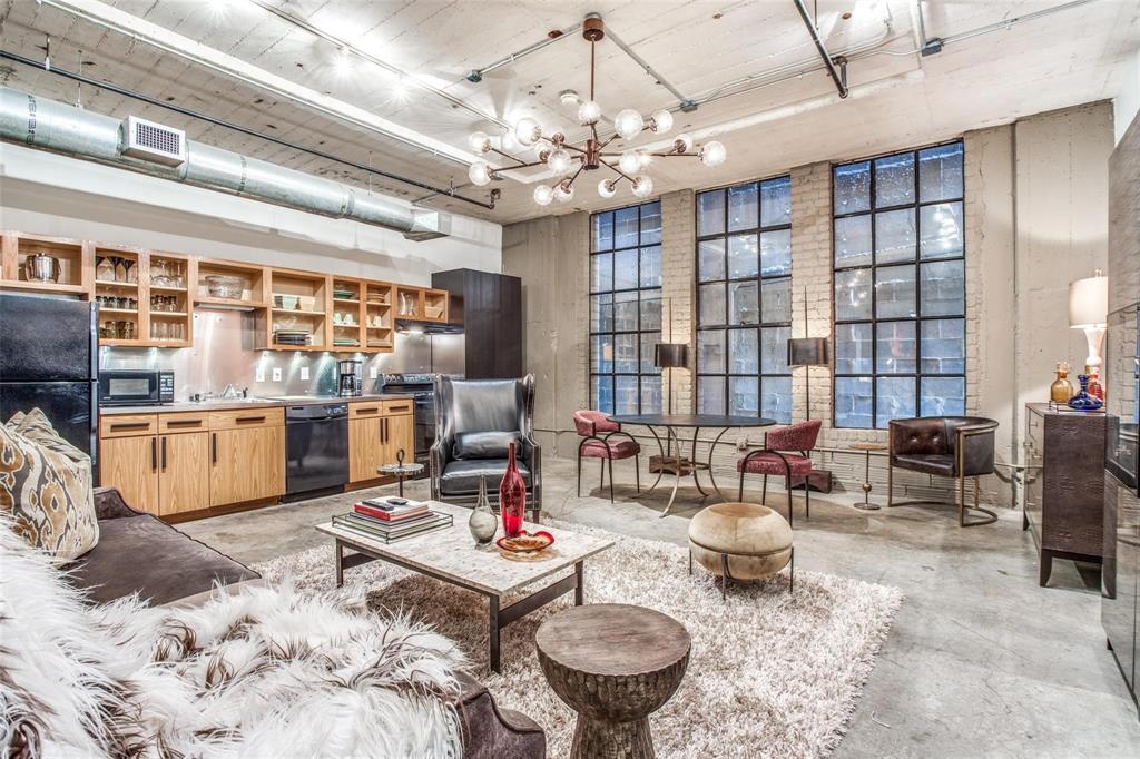 1122 Jackson Street, Unit 322 Dallas, TX 75202 - Photo 8 of 25 a living room with furniture a chandelier and a dining table