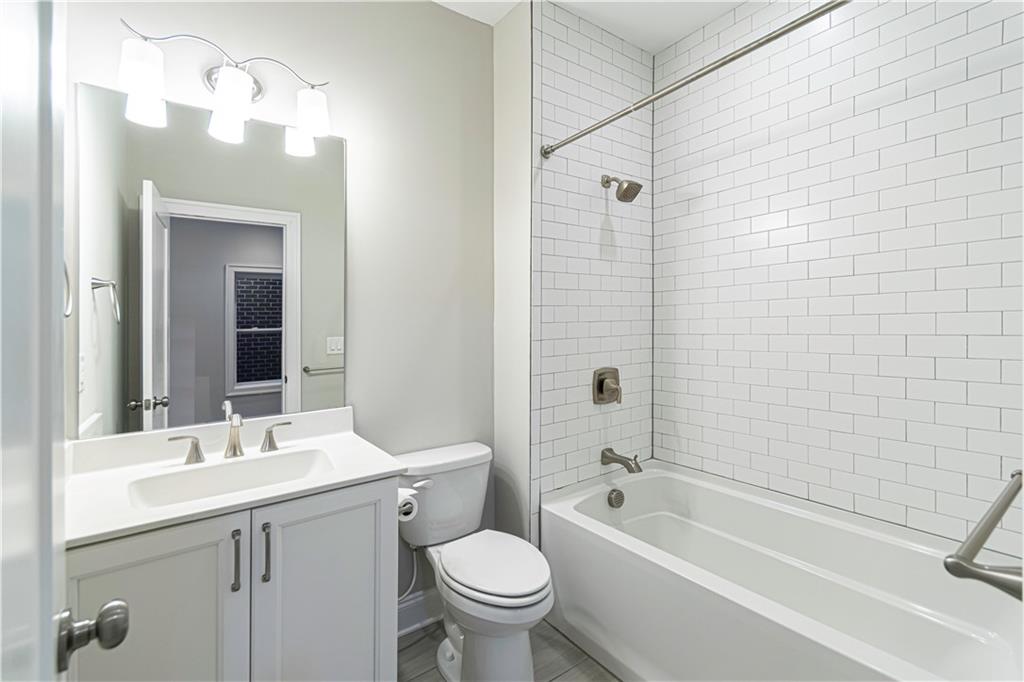 2006 Attell Way Decatur, GA 30033 - Photo 30 of 35 a bathroom with a bathtub shower sink mirror vanity and toilet