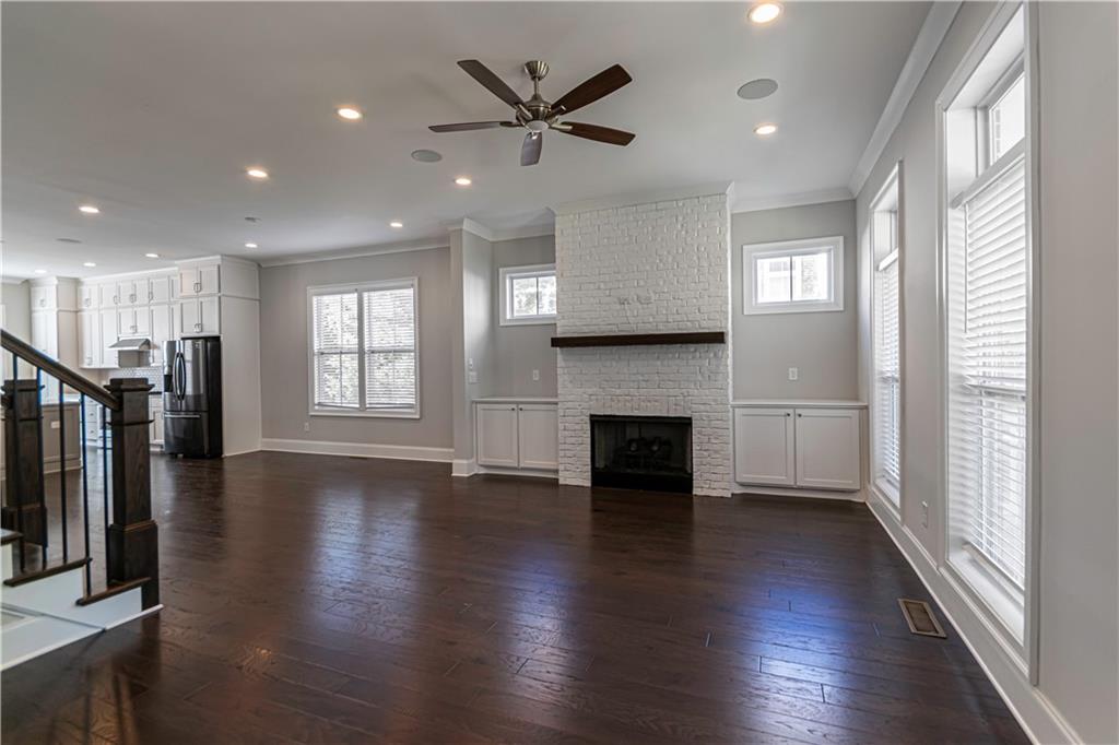 2006 Attell Way Decatur, GA 30033 - Photo 5 of 35 an empty room with wooden floor a ceiling fan and windows