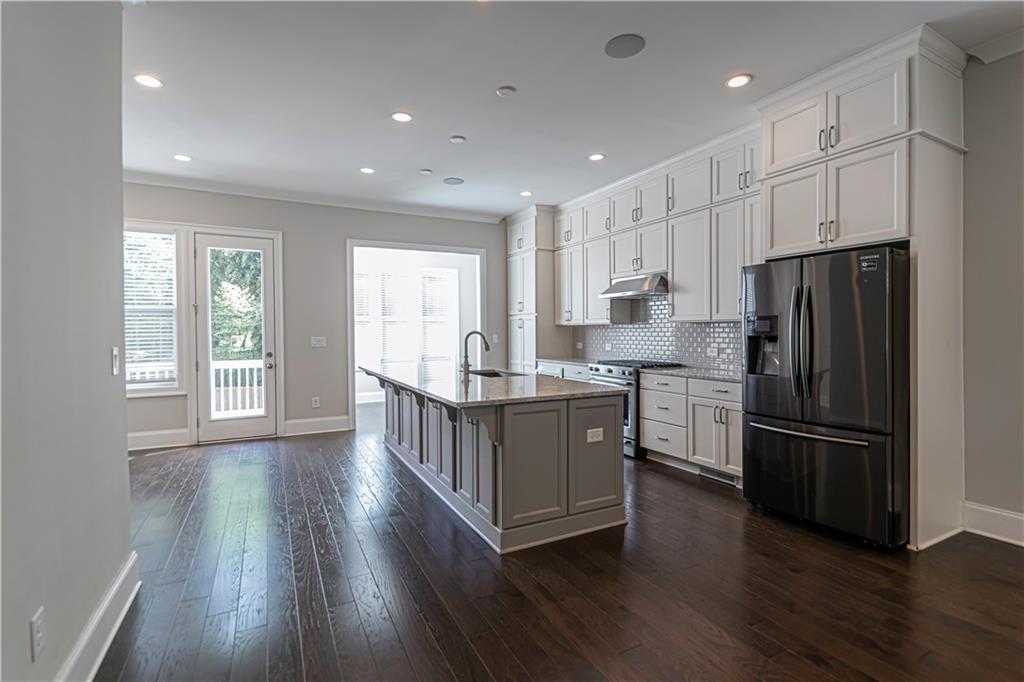 2006 Attell Way Decatur, GA 30033 - Photo 8 of 35 a kitchen with kitchen island wooden floors appliances and cabinets