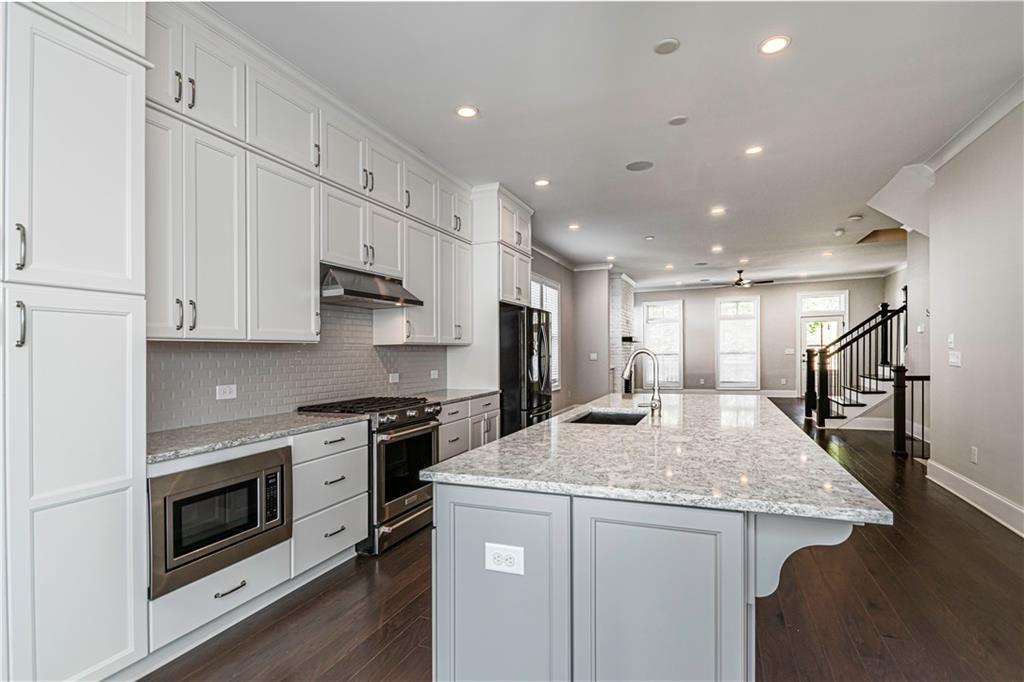 2006 Attell Way Decatur, GA 30033 - Photo 10 of 35 a kitchen with kitchen island a stove a sink and a refrigerator