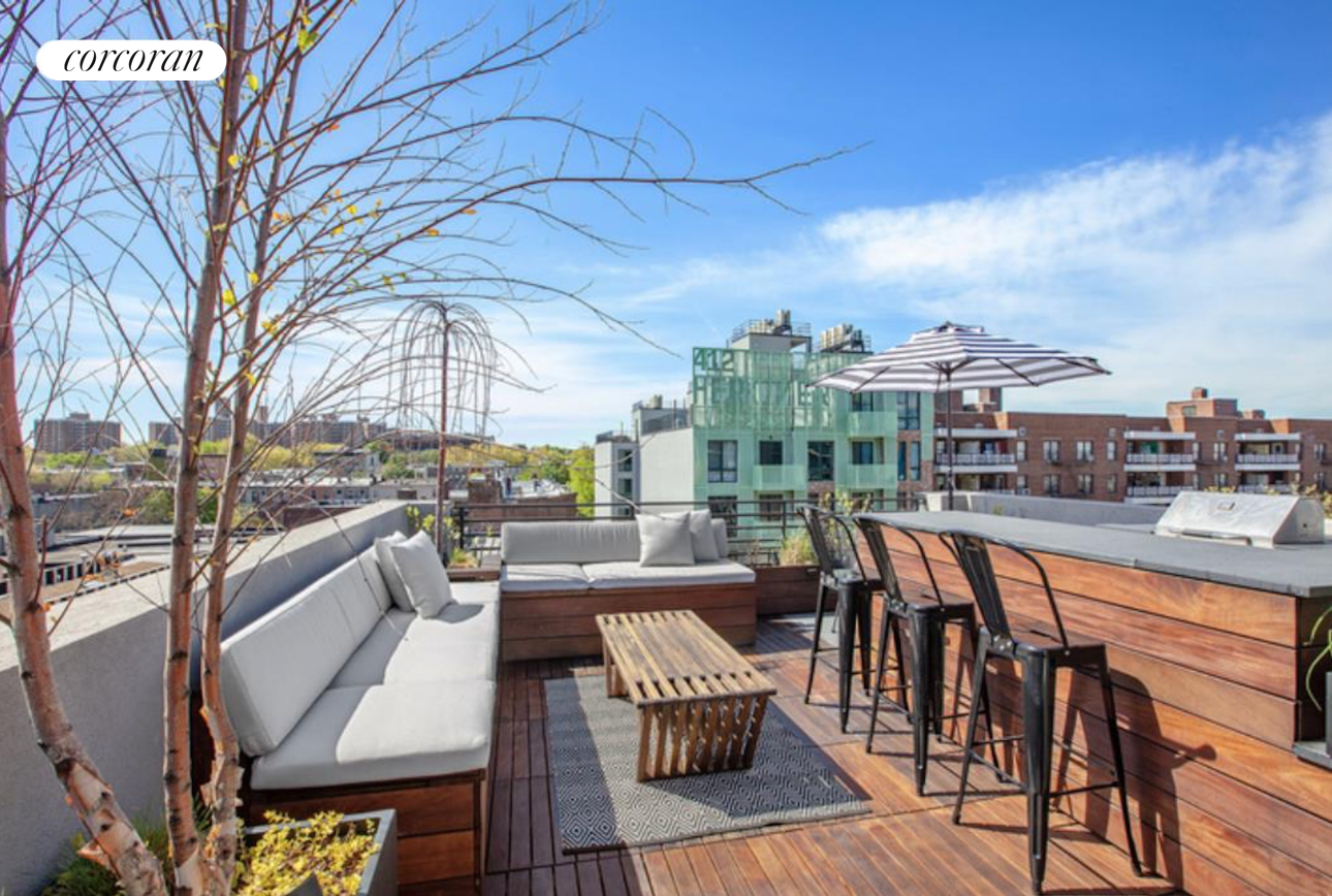 a view of a roof deck with table and chairs couches with wooden floor