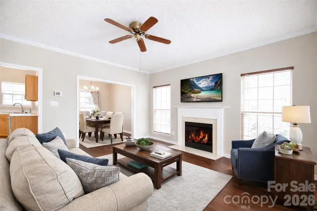 a living room with furniture fireplace and a window