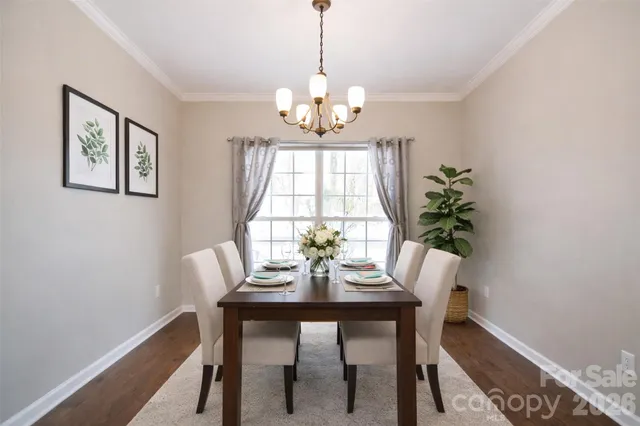 a view of a dining room with a table and chairs