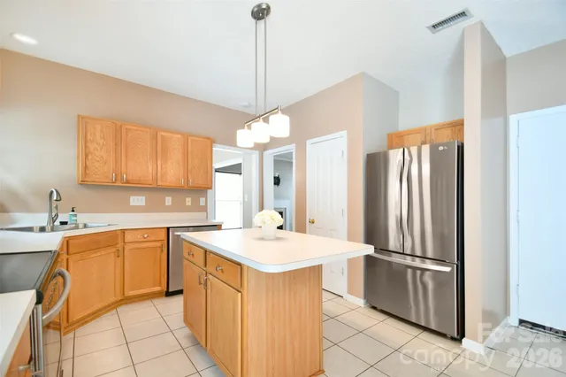 a kitchen with stainless steel appliances a refrigerator sink and stove