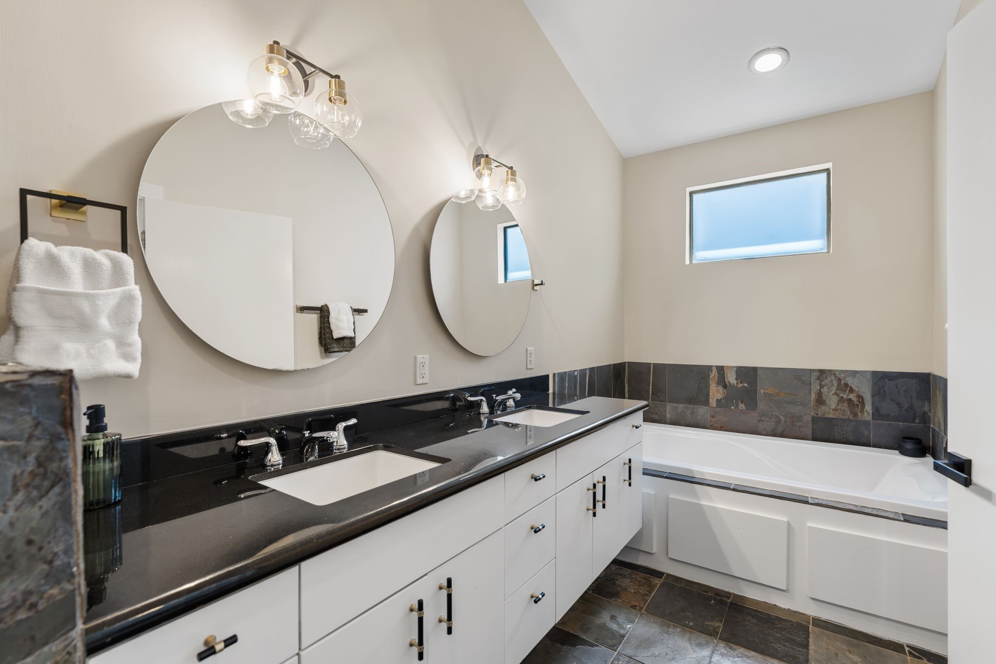 1039 Bonner Street, Unit 1039 Houston, TX 77007 - Photo 10 of 19 The primary bath has double sinks with lots of counter space. Great tub like a spa and separate shower. Nice to have the private window let the light in.